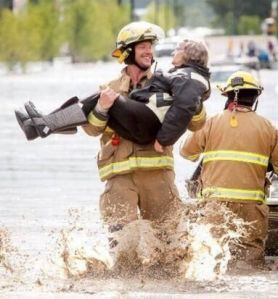 Calgary fireman evacuating flood victims